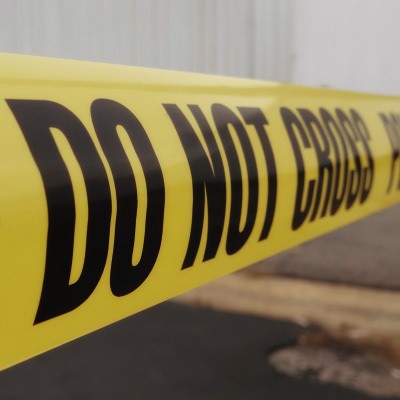 Crime scene barrier tape in front of a building